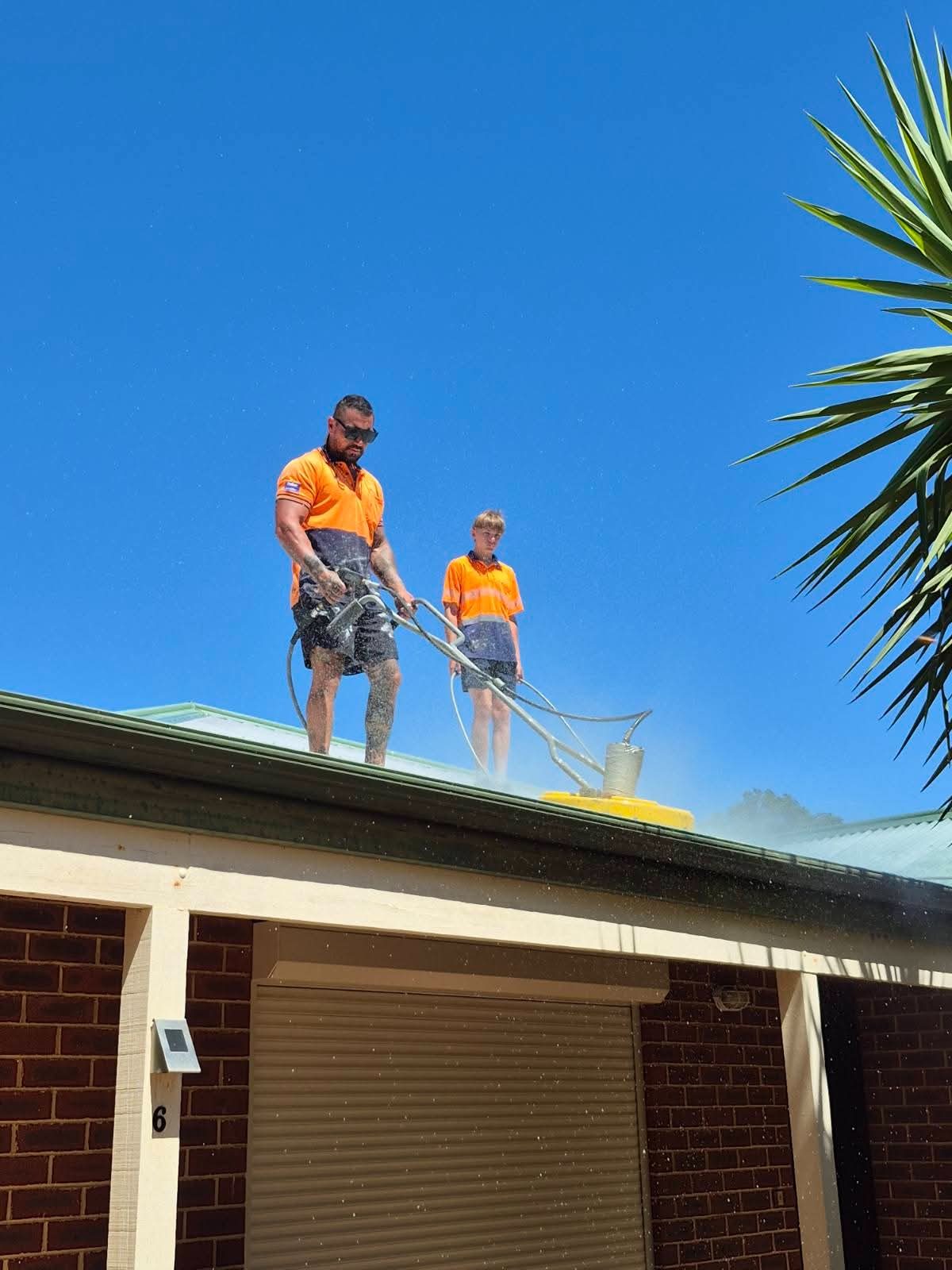 Pressure cleaning lifting years of grime off roof tiles