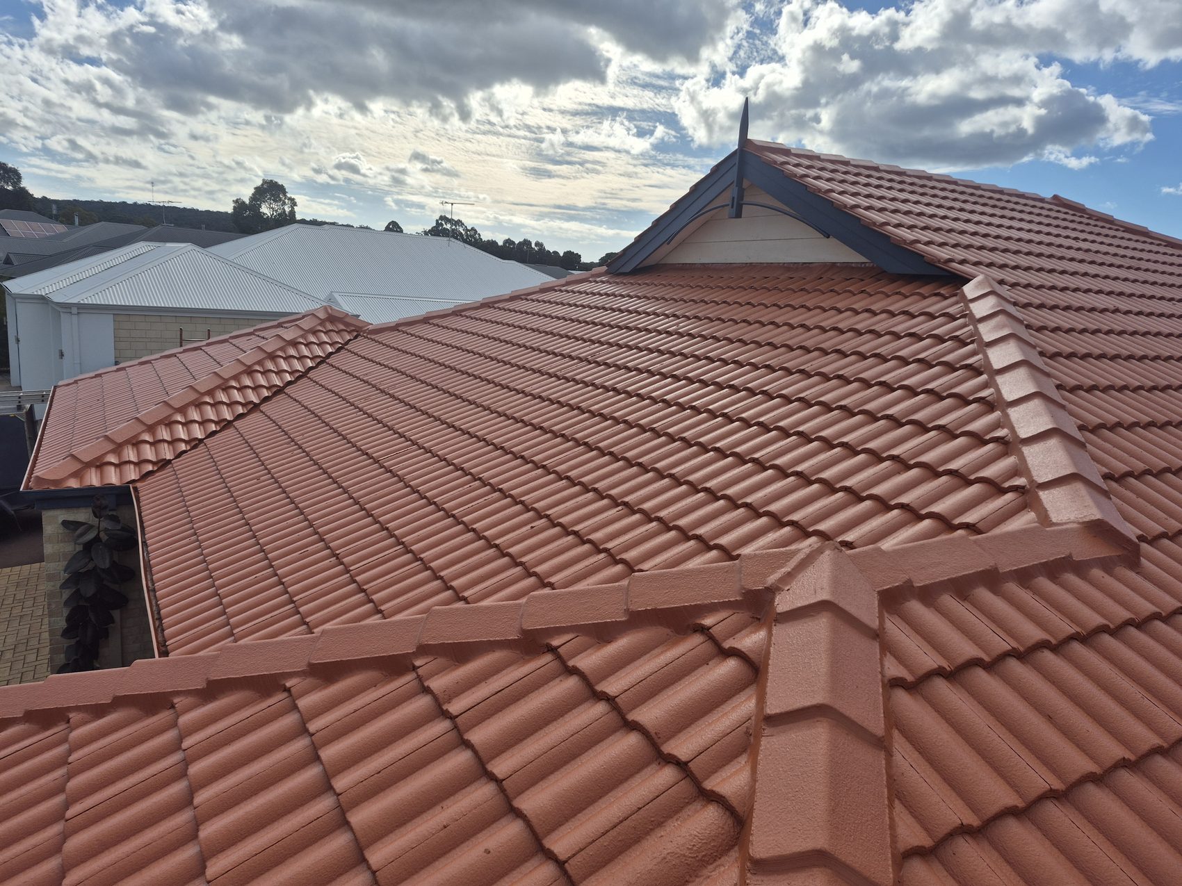 After: gable and ridge finished in fresh terracotta