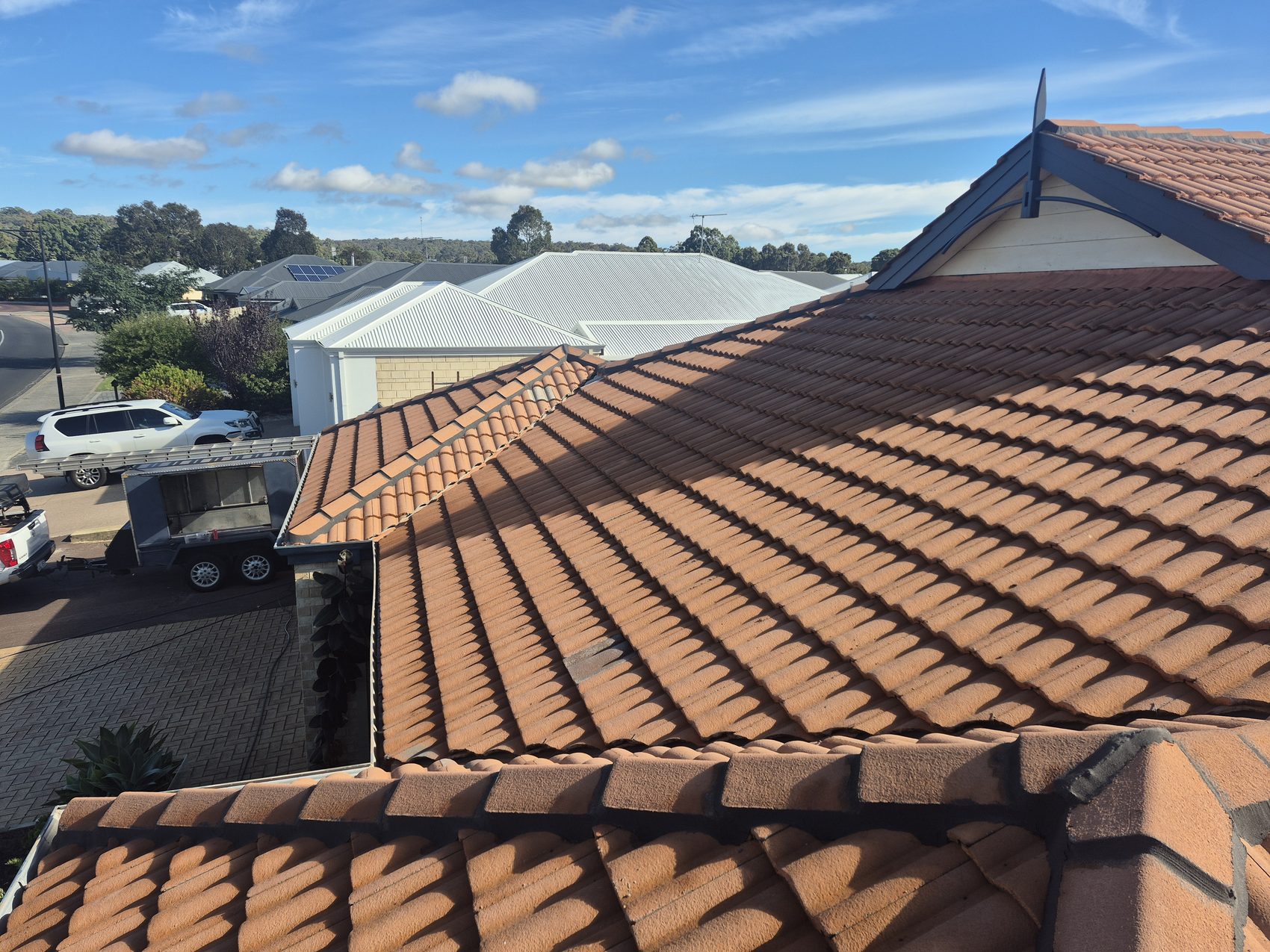 Before: chalky and patchy tiles across the whole roof