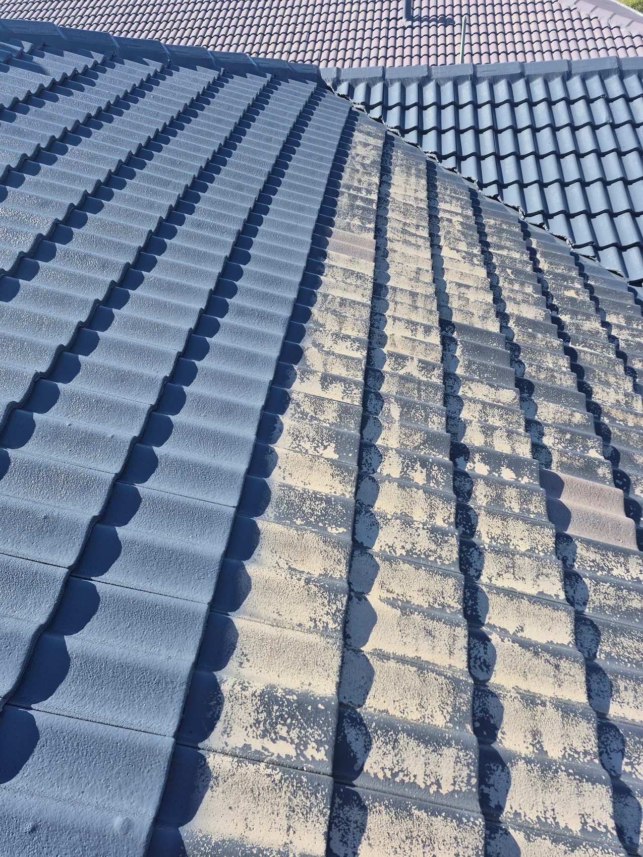 Charcoal roof tiles after cleaning and coating
