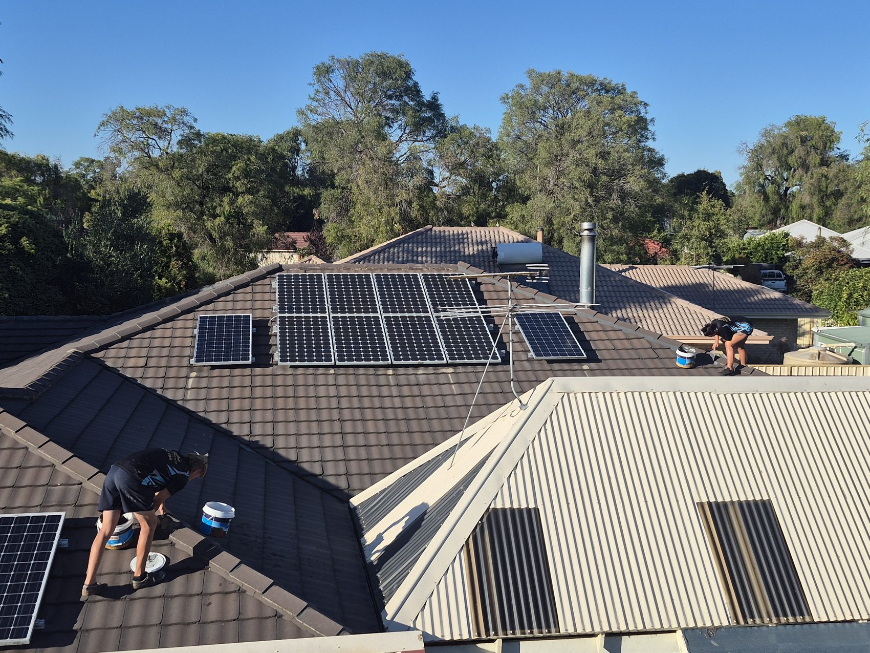 Working around solar panels on a charcoal tile roof